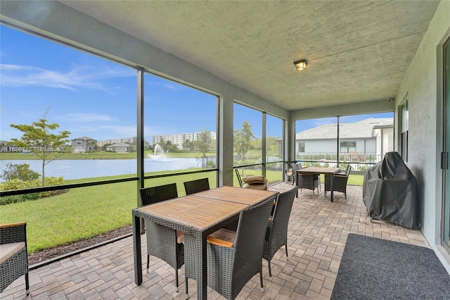 sunroom / solarium with a water view