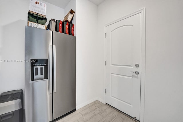 kitchen with light hardwood / wood-style floors and stainless steel fridge