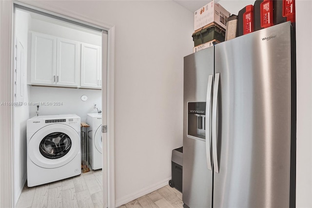 clothes washing area featuring washer and dryer and light hardwood / wood-style flooring