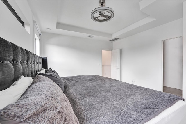 bedroom with a tray ceiling