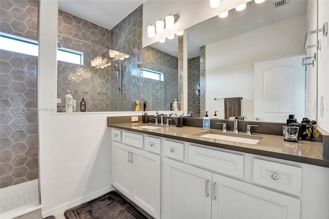 bathroom with walk in shower, a wealth of natural light, and vanity