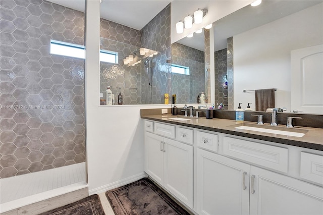 bathroom featuring vanity and tiled shower