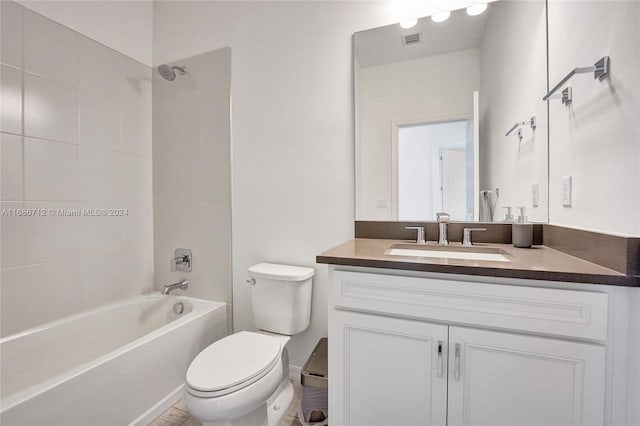 full bathroom with toilet, vanity, and tiled shower / bath