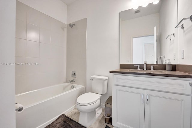 full bathroom with toilet, tiled shower / bath combo, vanity, and tile patterned flooring