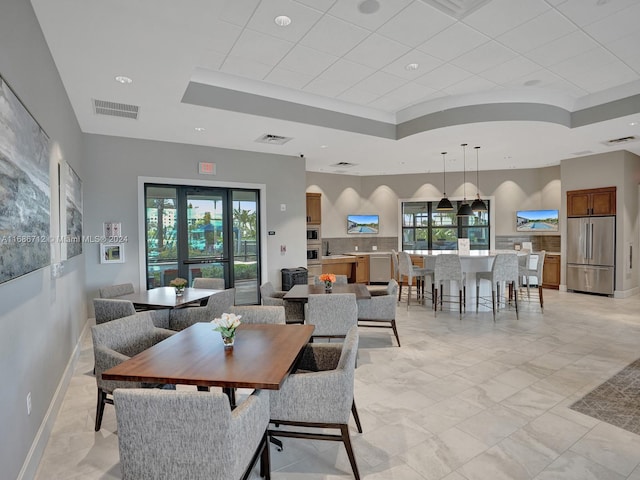 dining room featuring a raised ceiling