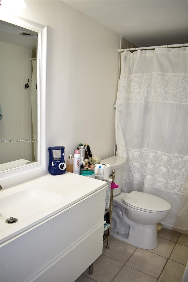 bathroom featuring tile patterned floors, vanity, and toilet