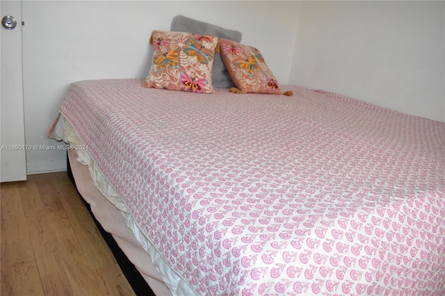 bedroom with wood-type flooring