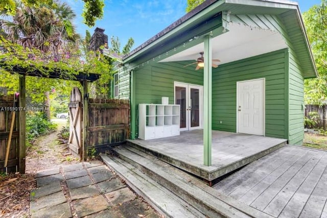 deck with french doors and ceiling fan