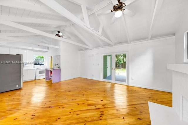 unfurnished living room with vaulted ceiling with beams, hardwood / wood-style flooring, and ceiling fan