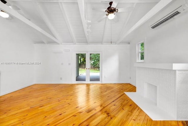 unfurnished living room with hardwood / wood-style floors, ceiling fan, a wall mounted AC, and lofted ceiling with beams