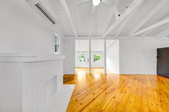 unfurnished living room with hardwood / wood-style floors, a wall unit AC, wood ceiling, and lofted ceiling with beams