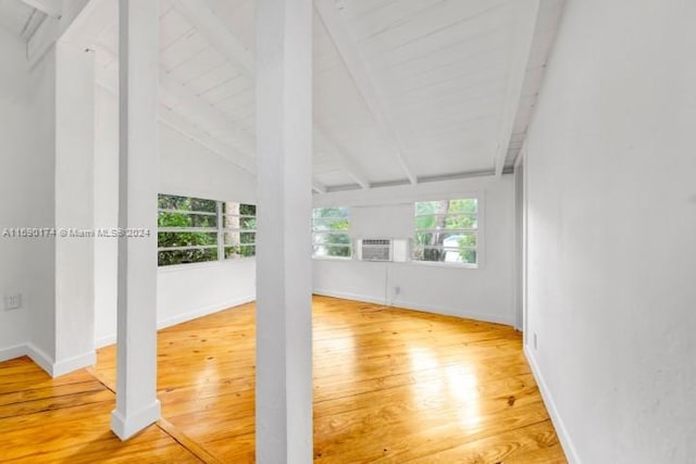 unfurnished sunroom featuring vaulted ceiling with beams