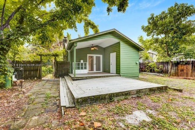 rear view of house with french doors and a wooden deck