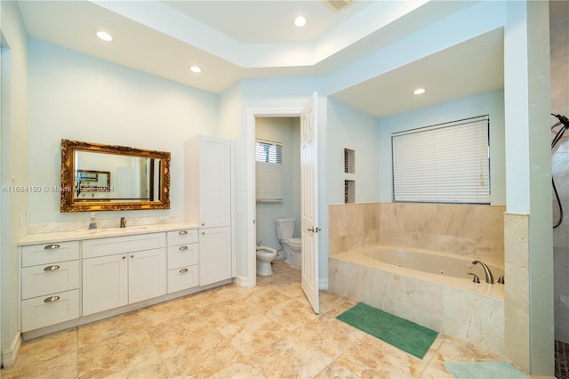 bathroom featuring vanity, a bidet, toilet, and a relaxing tiled tub