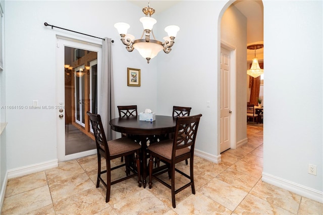 dining area featuring a notable chandelier