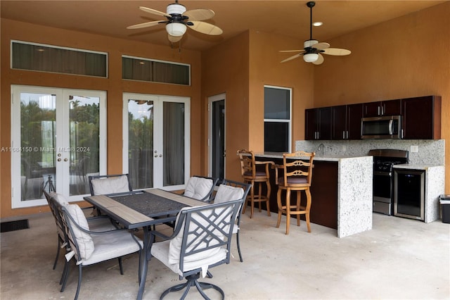 view of patio / terrace with an outdoor bar and ceiling fan