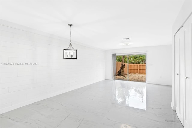 empty room featuring brick wall