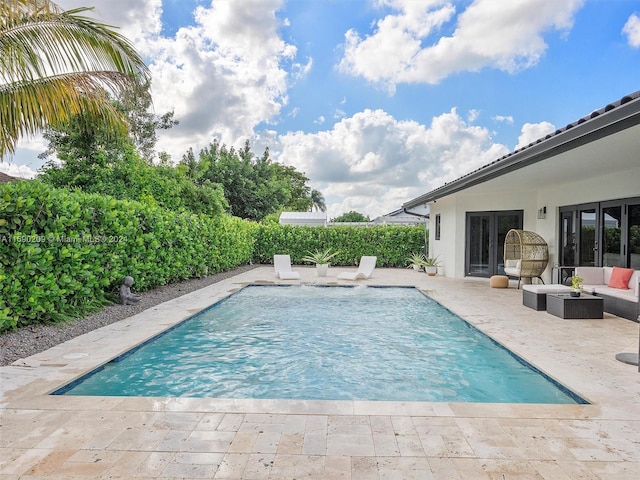 view of swimming pool with a patio and an outdoor living space