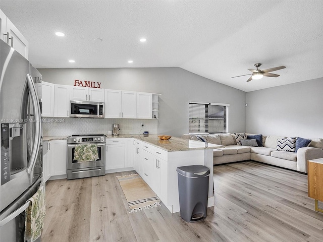 kitchen with light wood-type flooring, appliances with stainless steel finishes, decorative backsplash, white cabinets, and kitchen peninsula