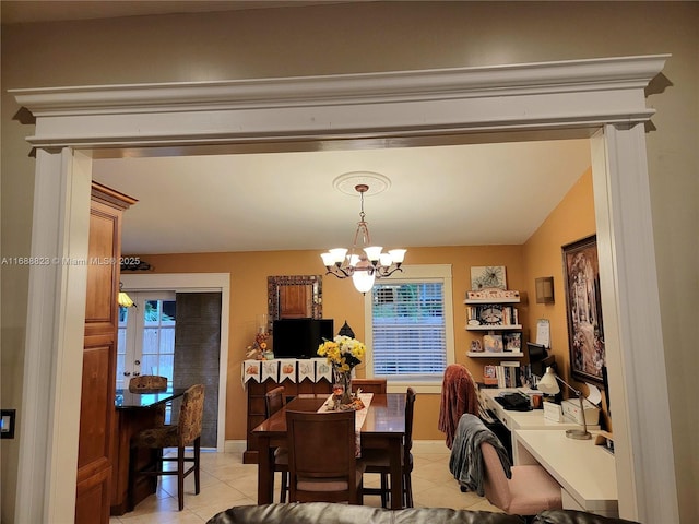 tiled dining area featuring a chandelier and vaulted ceiling