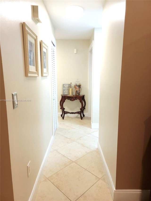 hall with light tile patterned floors