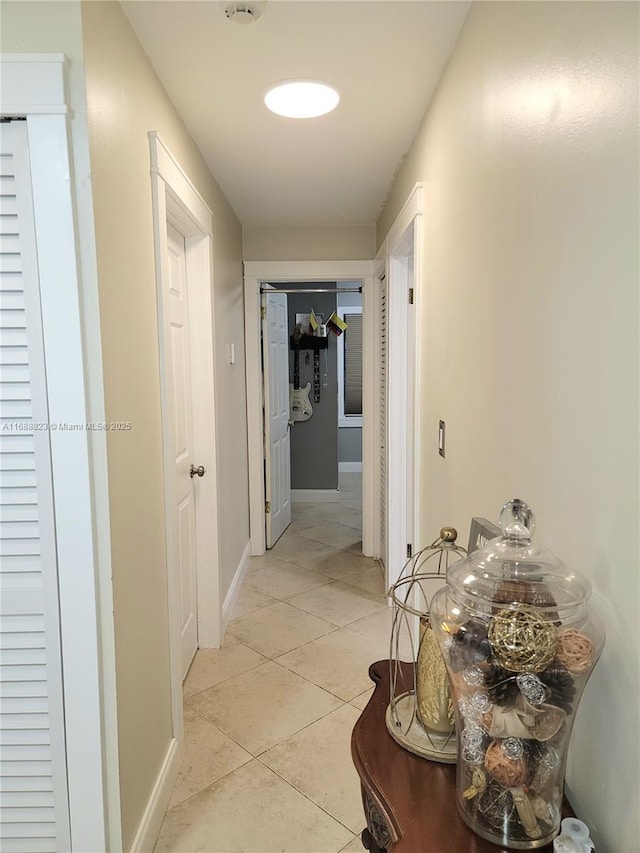 hallway featuring light tile patterned floors