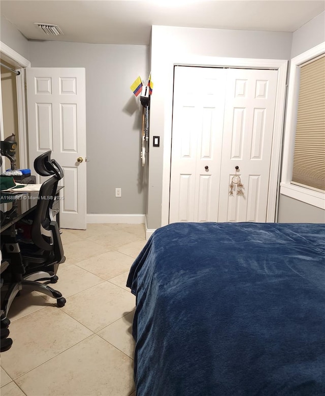 bedroom featuring a closet and light tile patterned floors