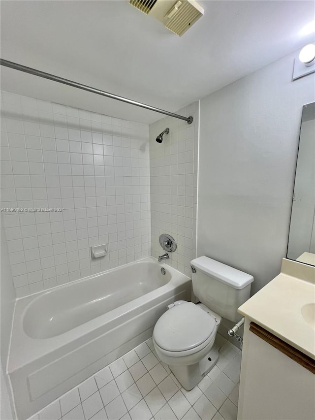 full bathroom featuring tile patterned flooring, vanity, toilet, and tiled shower / bath combo