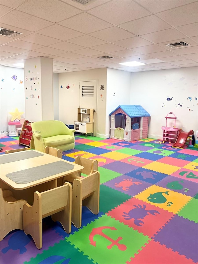 playroom with a paneled ceiling