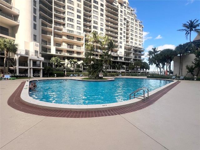 view of swimming pool featuring a patio area