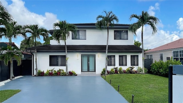 view of front facade featuring a front yard and french doors