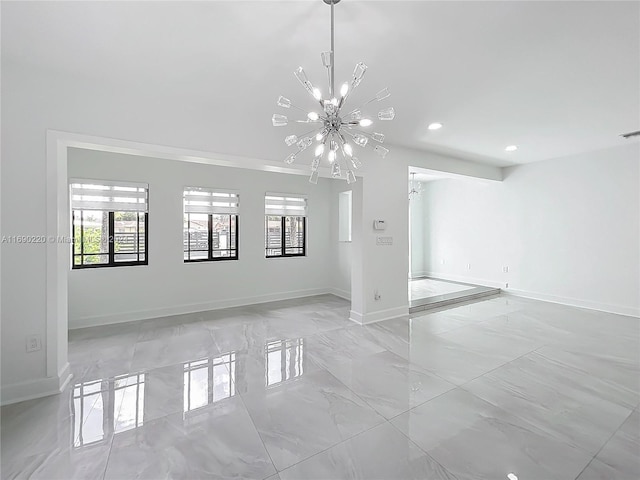 unfurnished room featuring a notable chandelier