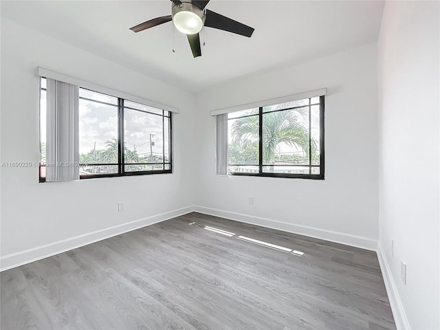 spare room with wood-type flooring and ceiling fan