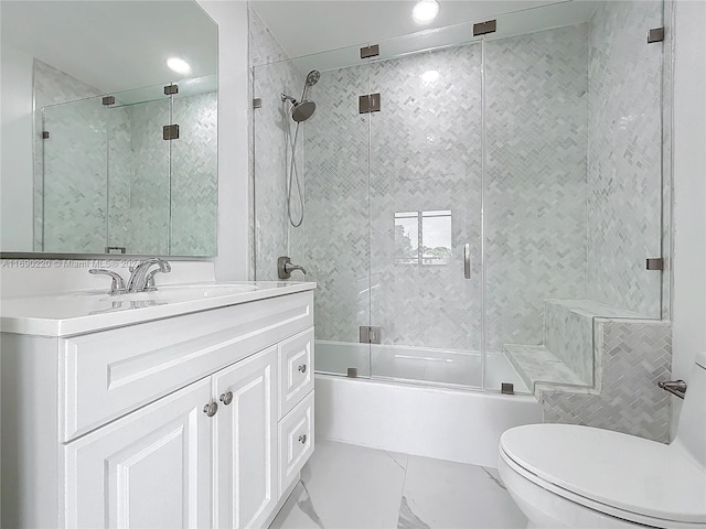 full bathroom with shower / bath combination with glass door, vanity, and toilet