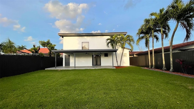 back of house with a yard and a patio area