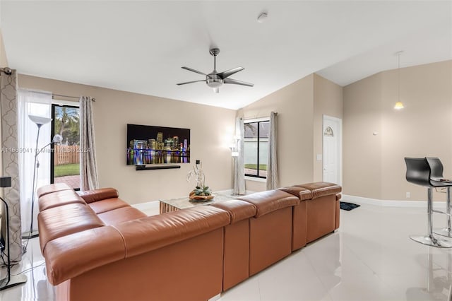 tiled living room featuring ceiling fan and lofted ceiling