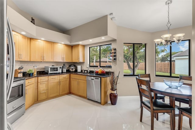 kitchen featuring stainless steel appliances, decorative light fixtures, light brown cabinetry, an inviting chandelier, and sink