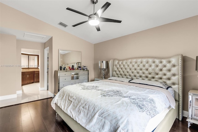 bedroom featuring ensuite bath, ceiling fan, dark hardwood / wood-style floors, and vaulted ceiling