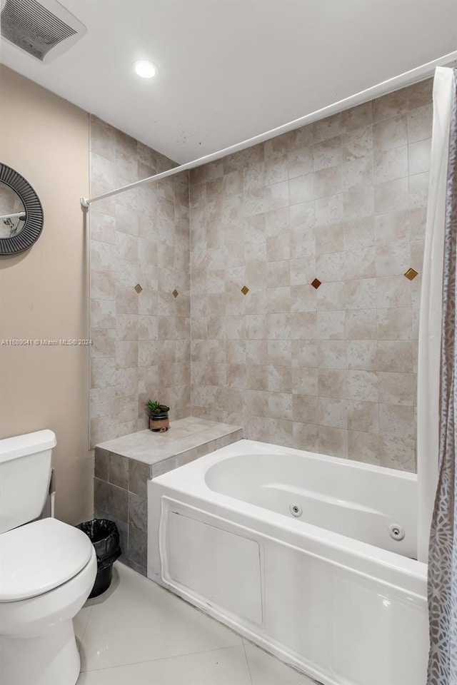 bathroom featuring shower / tub combo with curtain, toilet, and tile patterned flooring