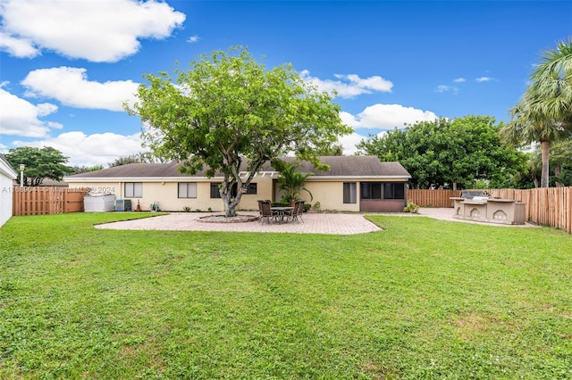 rear view of property with a patio area, a yard, and area for grilling