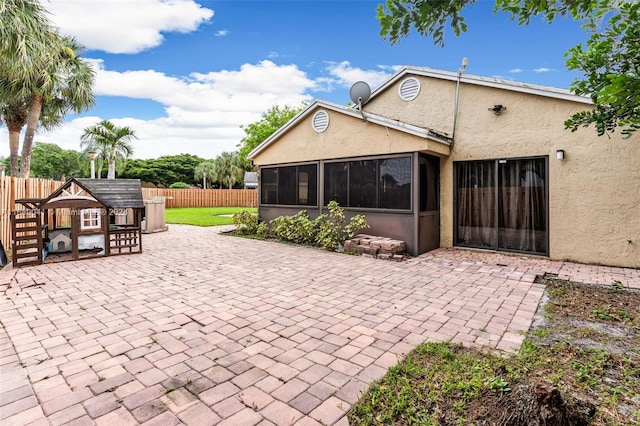 back of house with a patio and a sunroom