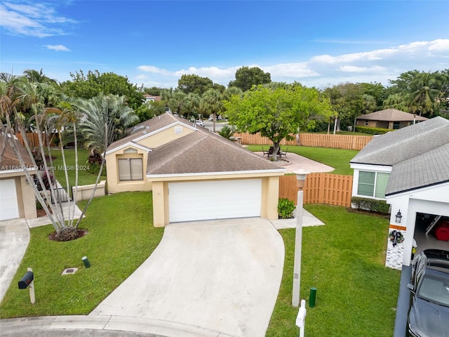 view of front facade with a front yard and a garage