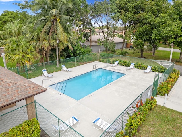 view of pool featuring a yard and a patio area