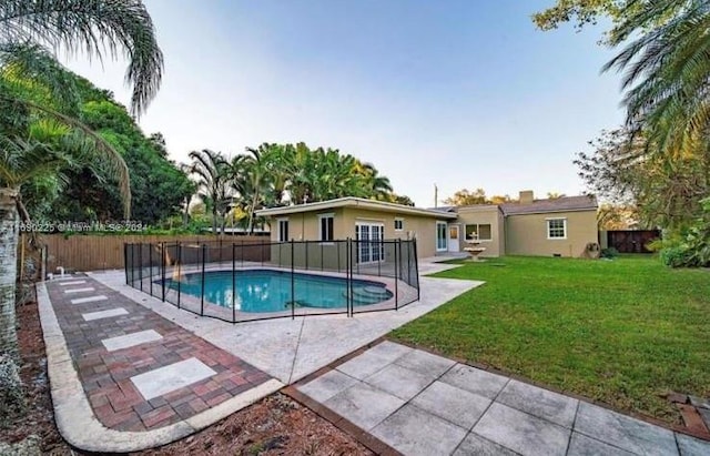 view of swimming pool with a yard and a patio area