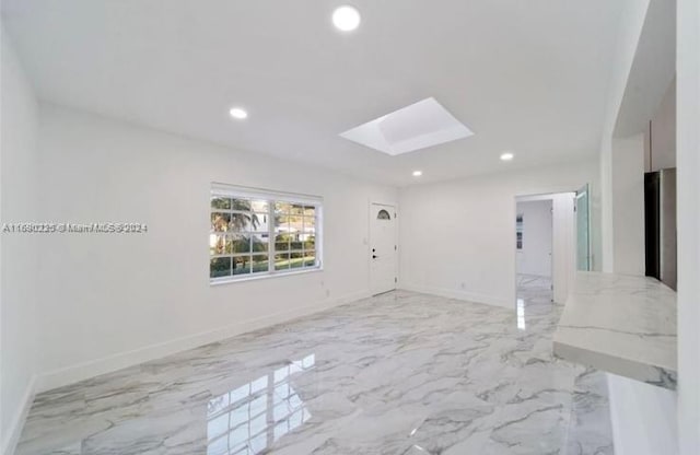 spare room with a skylight