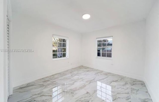 spare room featuring plenty of natural light