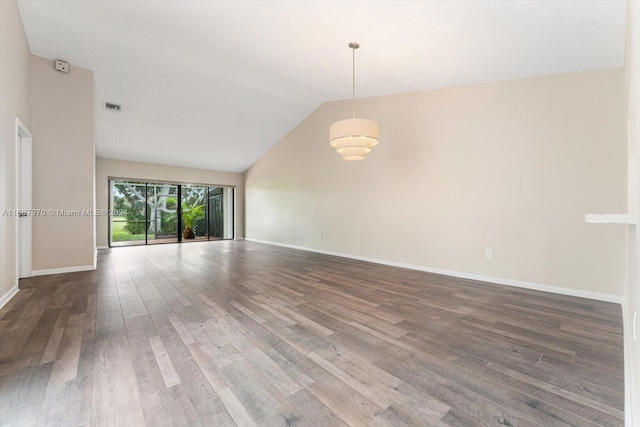 unfurnished room featuring lofted ceiling and dark hardwood / wood-style floors