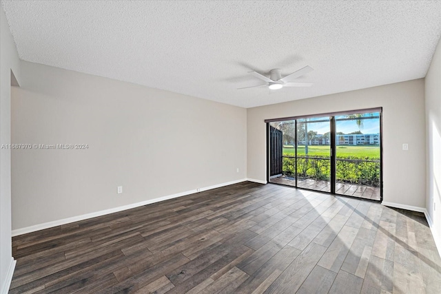 empty room with ceiling fan, dark hardwood / wood-style flooring, and a textured ceiling