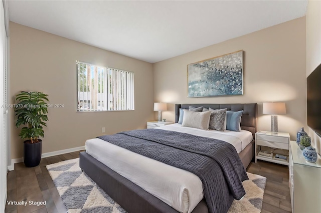 bedroom with dark wood-type flooring