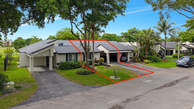 ranch-style house with a garage and a front lawn